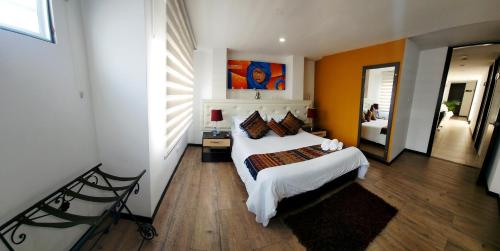 a bedroom with a large bed in a room at Hotel San Blass Boutique in Pasto