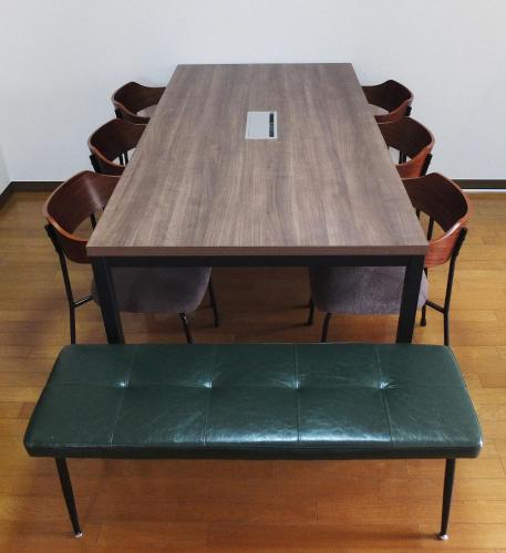 a wooden table and chairs with a bench around it at Harbor Nook - Family Stay & Free 2 Car Parking in Takamatsu