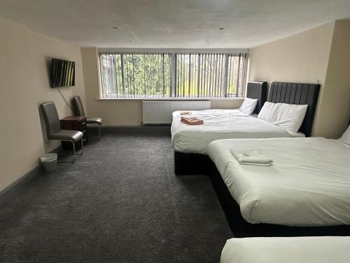 a hotel room with two beds and a window at Park hotel in Bradford