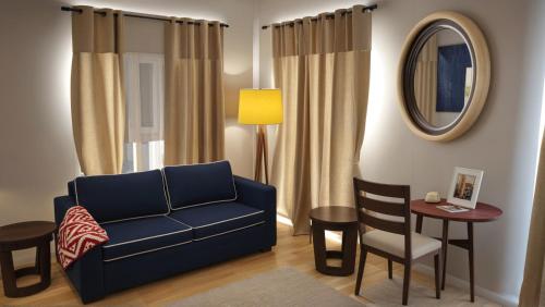 a living room with a blue couch and a table at Stylish 2, 3 and 5 Bedroom Entire Homes Near Art Deco and LA Hotspots in Los Angeles