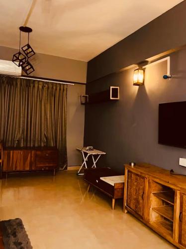a living room with a flat screen tv on a wall at Skyline Serenity by Vantage View in Nalmatha