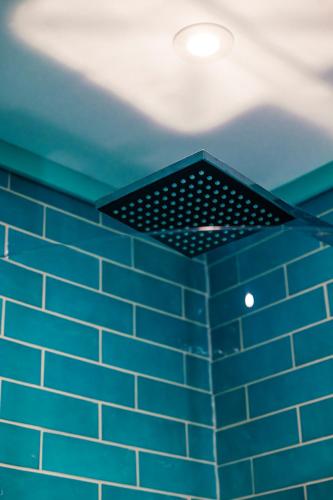 a blue tiled ceiling with a light on it at Skye Blue Bothy in Teangue