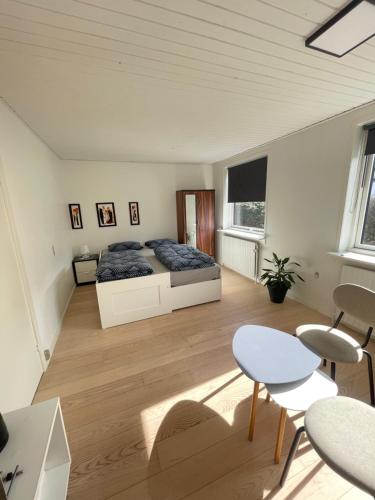 a bedroom with a bed and a table and chairs at Room in Billund near Lego House & Legoland in Billund