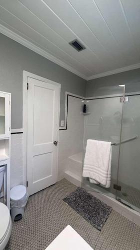 a bathroom with a shower and a toilet and a towel at The Nest in Gainesville