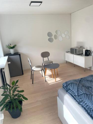 a living room with a couch and chairs and a kitchen at Room in Billund near Lego House & Legoland in Billund