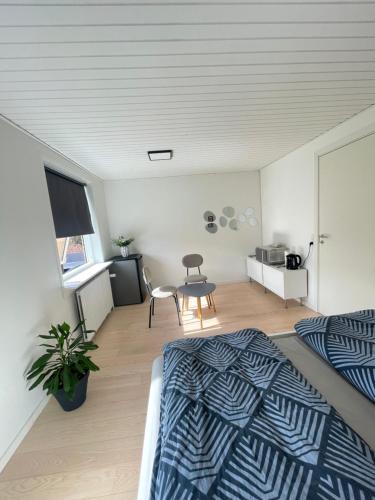 a bedroom with a bed and a table in it at Room in Billund near Lego House & Legoland in Billund