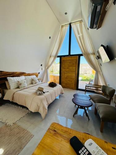a bedroom with a large bed and a table at Andinas de Uco Lodge in La Consulta