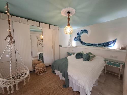 a bedroom with a bed and a mirror at Au Jardin d'Armand in Sant Pere de Ribes