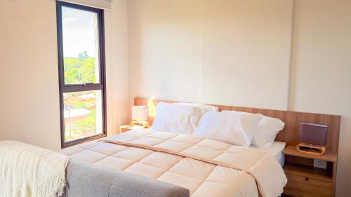 a bedroom with a large bed and a television at Civis Jardinia Sky Studio 4B Pool & Sauna in Luque