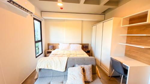 a small bedroom with a bed and a desk at Civis Jardinia Studio 1B Pool & Sauna in Luque