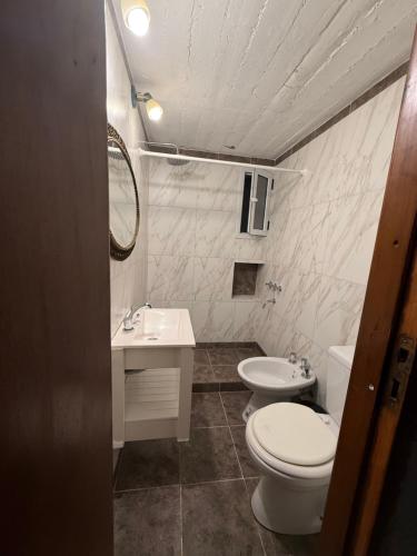 a white bathroom with a toilet and a sink at Le de nery in Ostende