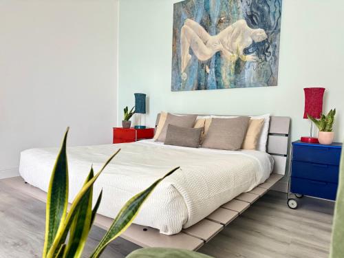 a bedroom with a bed and a painting on the wall at Casa Flavia-Comfort e relax nel cuore di Ariccia in Ariccia