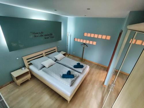 a bedroom with a bed with two blue shoes on it at Mézi Lazy in Gyenesdiás