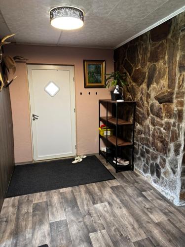 a room with a door and a stone wall at Minimalist luxury room in Zgornje Hoče