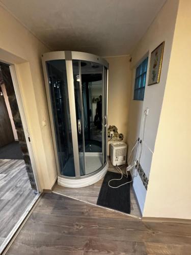 a room with a glass shower in the corner of a room at Minimalist luxury room in Zgornje Hoče