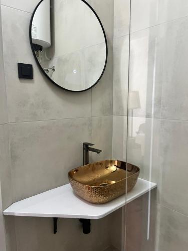 a bathroom with a bowl sink and a mirror at Ivan&Anka Selce apartments in Selce