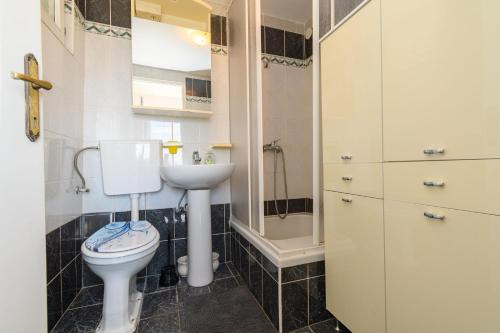 a bathroom with a toilet and a sink at Apartment Tena in Kraljevica
