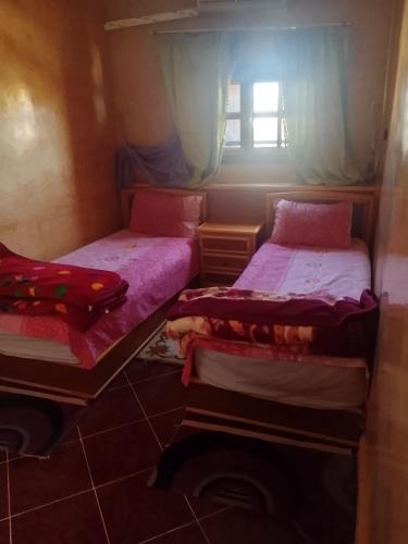 a room with two twin beds and a window at Premium Services in Tatta