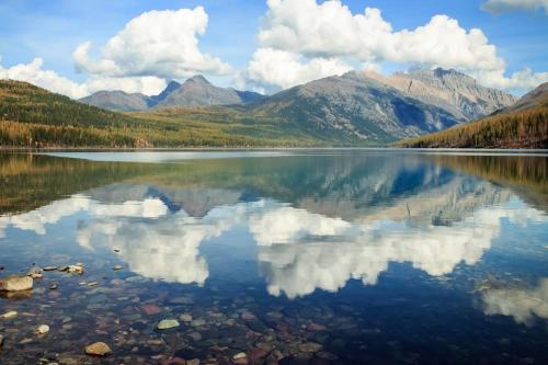 a reflection of the mountains in a lake at Big Sky Ski Condo in Big Sky