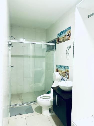 a bathroom with a shower and a toilet and a sink at Hotel Barcelona in Montería