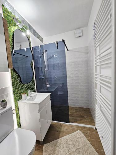 a bathroom with a toilet and a sink and a shower at Happy Place Făgăraș in Făgăraş