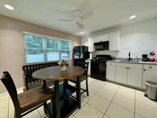 a kitchen with a wooden table and a dining room at The Nest in Gainesville