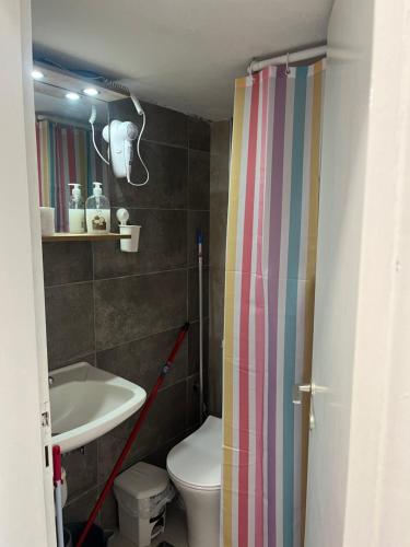 a small bathroom with a toilet and a sink at Megalou Alexandrou in Nea Moudania