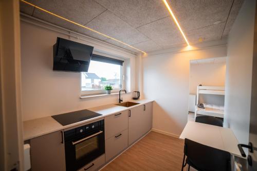 a kitchen with a sink and a stove top oven at Modern Apartment With Fitness in Hejls