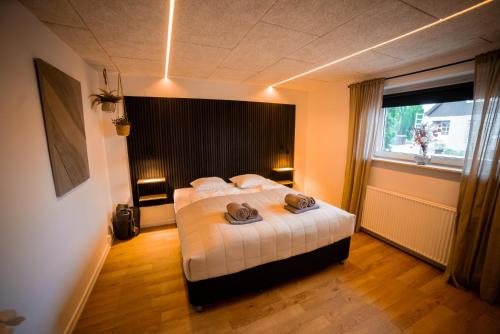 a bedroom with a bed and a large window at Modern Apartment With Fitness in Hejls