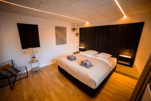 a bedroom with a large bed with two pillows on it at Modern Apartment With Fitness in Hejls