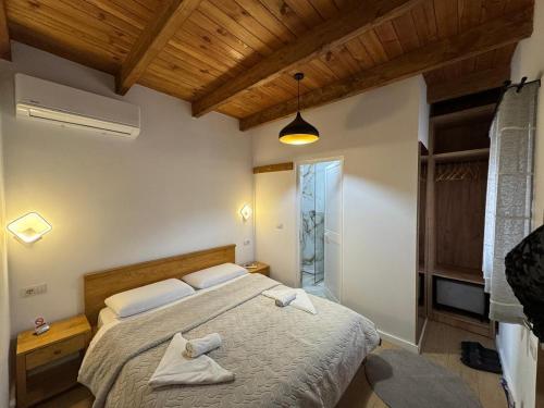 a bedroom with a bed with two towels on it at Bujtina Carku in Theth