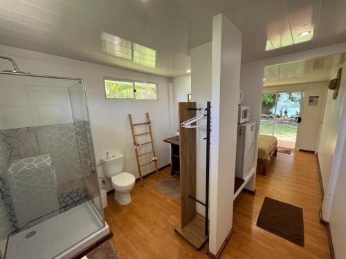 a bathroom with a shower and a toilet at Panorama Bungalow in Tahaa