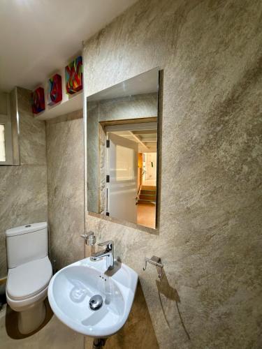 a bathroom with a toilet and a sink and a mirror at Dar Divinus - Eat, Wine, Sleep in Rabat