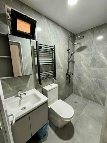 a bathroom with a white toilet and a sink at Kobuleti hotel 656 in Kobuleti