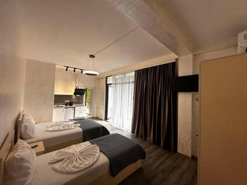 a hotel room with two beds and a kitchen at Kobuleti hotel 656 in Kobuleti