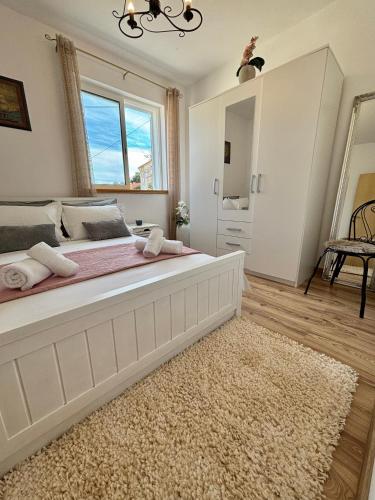 a bedroom with a large bed with a rug at Apartment Fortuna in Korčula