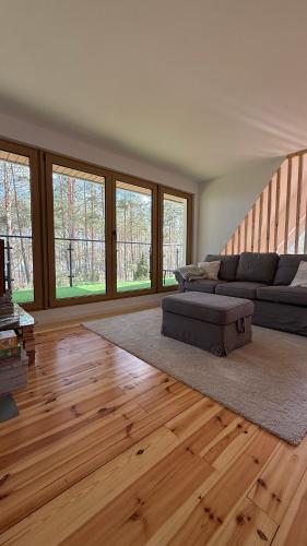 a living room with two couches and a couch at Szałas na Hałas in Lubiana