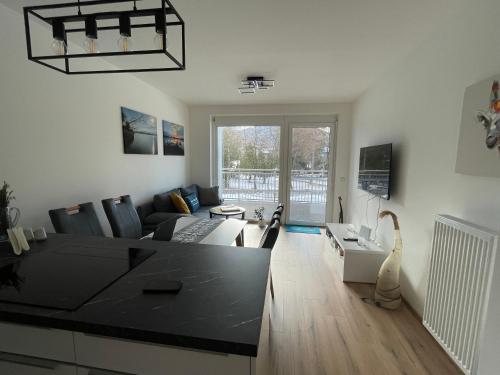 a living room with a couch and a table at Appartement Eveline Pörtschach in Pörtschach am Wörthersee