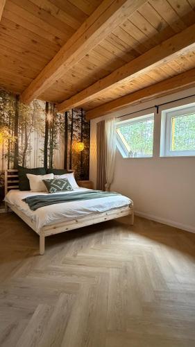 a bedroom with a large bed in a room at Szałas na Hałas in Lubiana