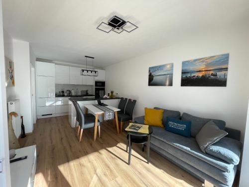 a living room with a couch and a table at Appartement Eveline Pörtschach in Pörtschach am Wörthersee