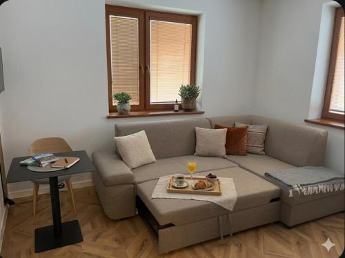 a living room with a couch and a table at Nido in the center in Poprad