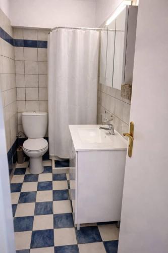 a bathroom with a toilet and a sink and a shower at Sun Suite in Sitia