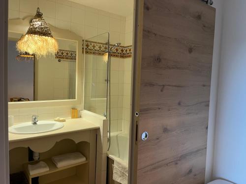 a bathroom with a sink and a mirror at Côte d azur Magnifique studio in Les Issambres