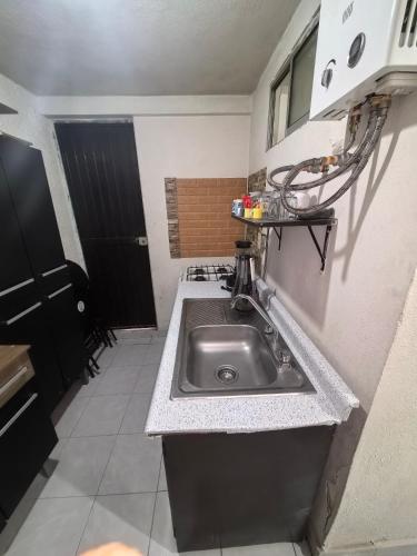 a kitchen with a stainless steel sink in a room at Casa Constructor staff colaboradores in Cabo San Lucas