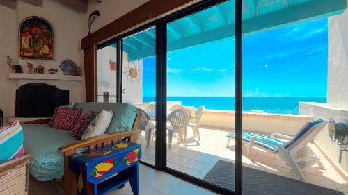 a living room with a view of the ocean at Warm & Charming Beachfront Condo Las Olas II 8 in Puerto Peñasco