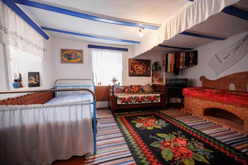 a bedroom with two bunk beds and a fireplace at Pensiunea Casa Sobarului in Molovata