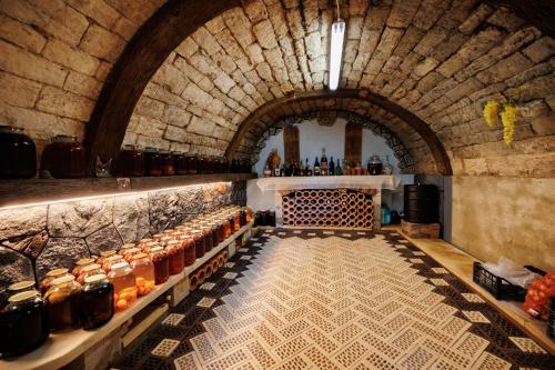 a room with a bunch of bottles on a counter at Pensiunea Casa Sobarului in Molovata