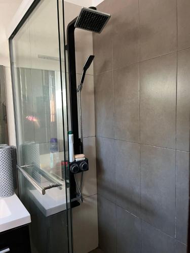 a shower with a glass door in a bathroom at Casa en Pocitos in Montevideo