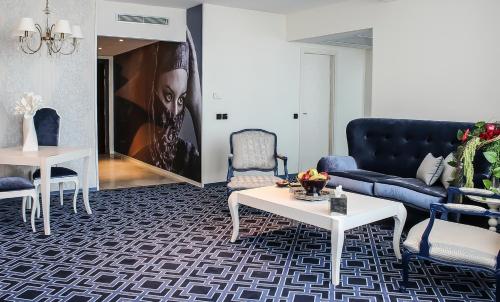 a living room with a couch and a table at Grand Mogador City Center in Casablanca