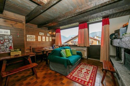 a living room with a green couch and a table at Arianna - Happy Rentals in Livigno